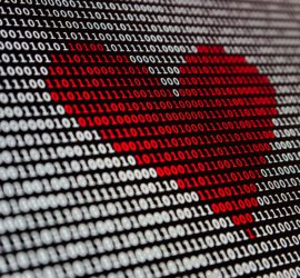 Heart typed on computer in binary code