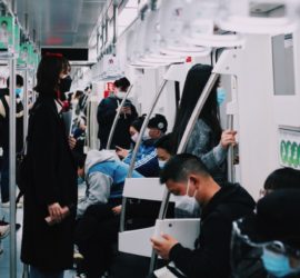 Image of people in masks in subway car