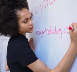 Woman writing on a white board