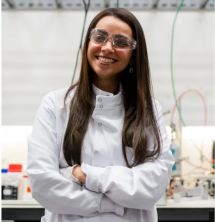 Stock photo of a young scientist smiling in a lab coat