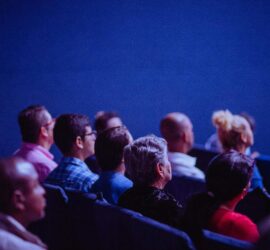 People in a movie theater watching a film