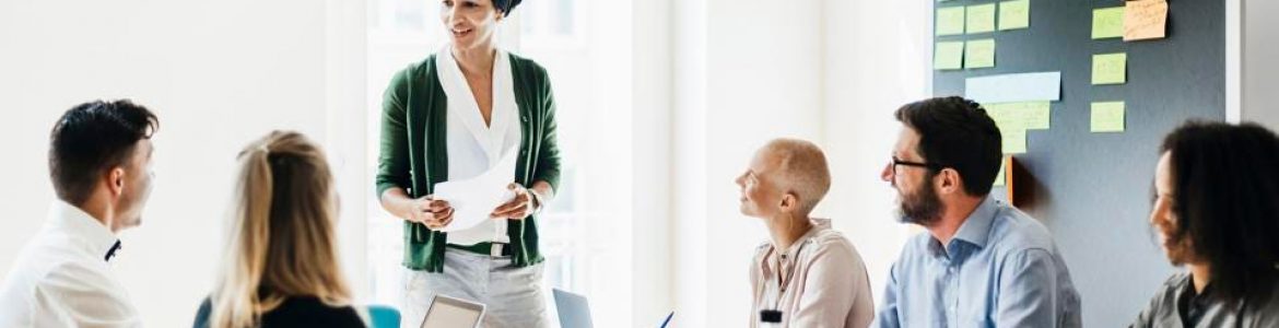 Woman leading conference room discussion with other professionals